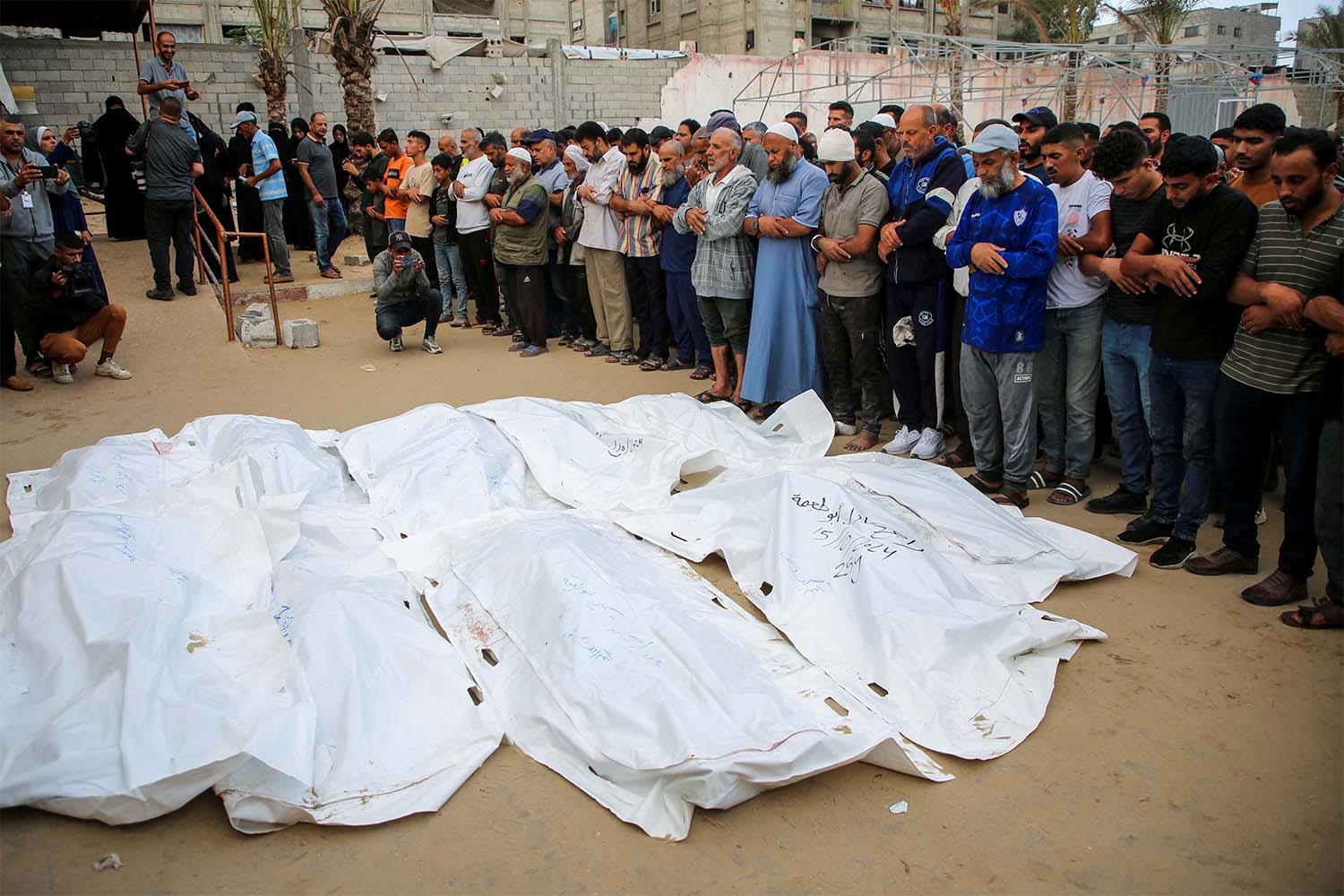 Funeral prayers next to the bodies of Palestinians including members of Abu Taima family, who were killed in an Israeli strike in Khan Younis