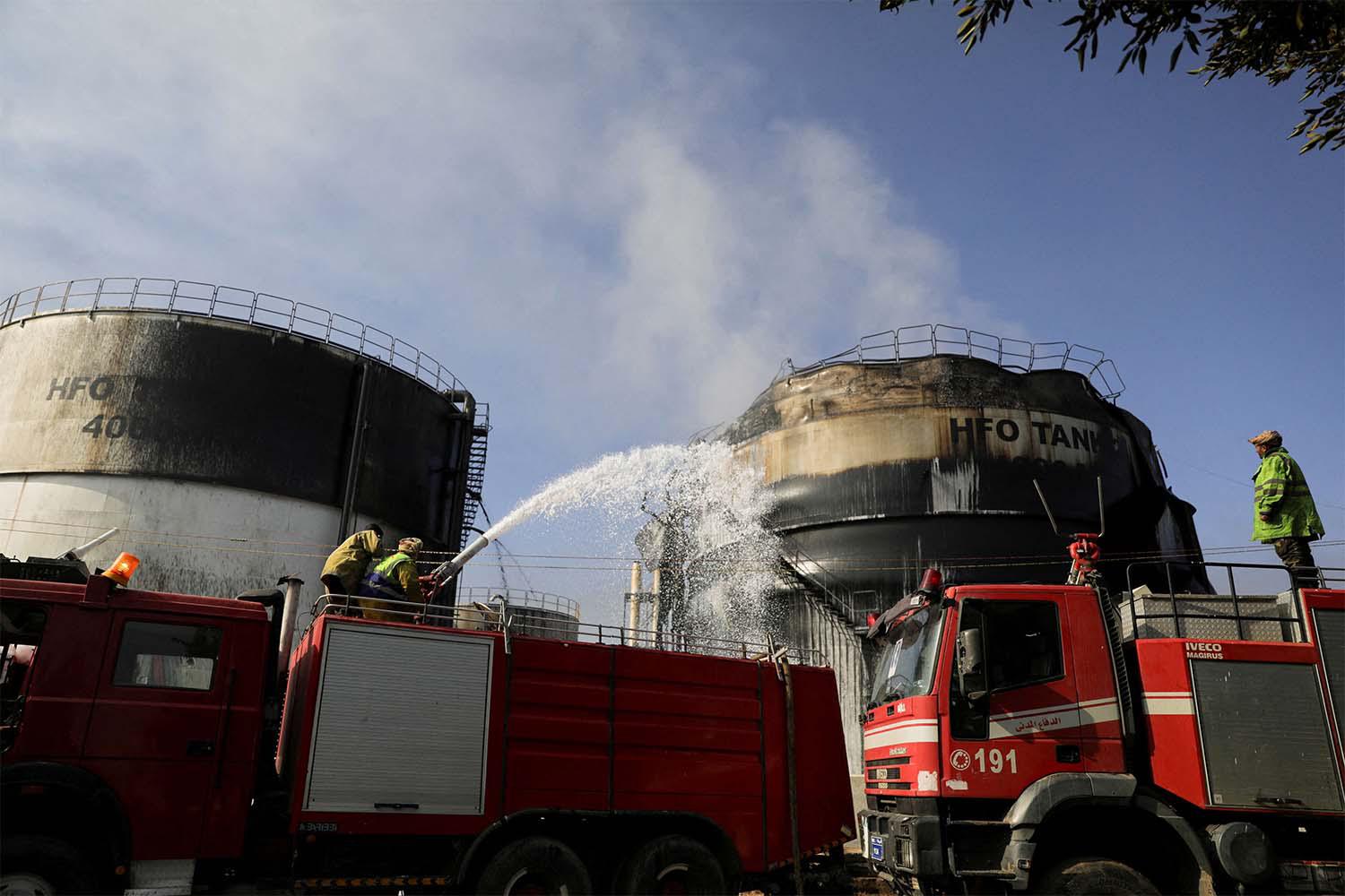 irefighters extinguish fire at a power station following Israeli airstrikes in Sanaa,