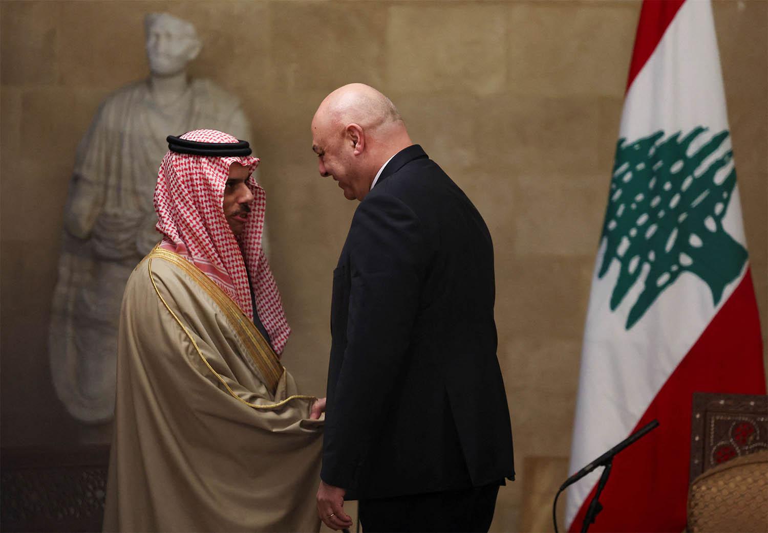 Saudi FM Prince Faisal bin Farhan Al Saud shakes hands with Lebanese President Joseph Aoun at the presidential palace, in Baabda