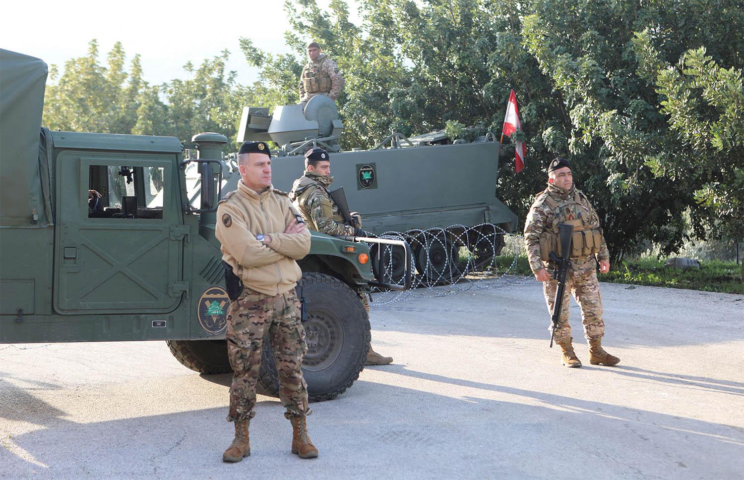 Lebanese soldiers stand at the entrance of Deir Mimas
