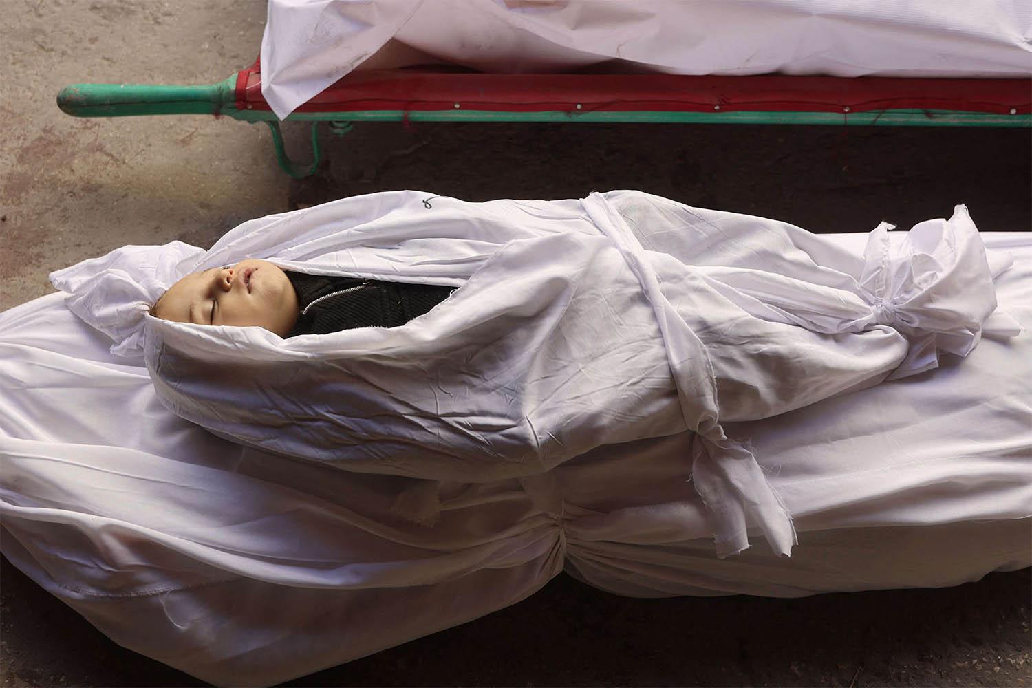 The shrouded body of a child killed in an overnight Israeli airstrike on the Gaza Strip 
