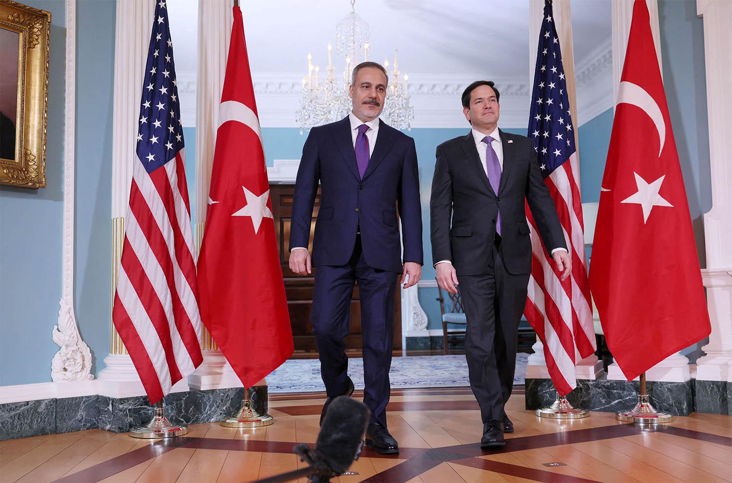 US Secretary of State Marco Rubio walks into the room with Turkish Foreign Minister Hakan Fidan at the State Department in Washington