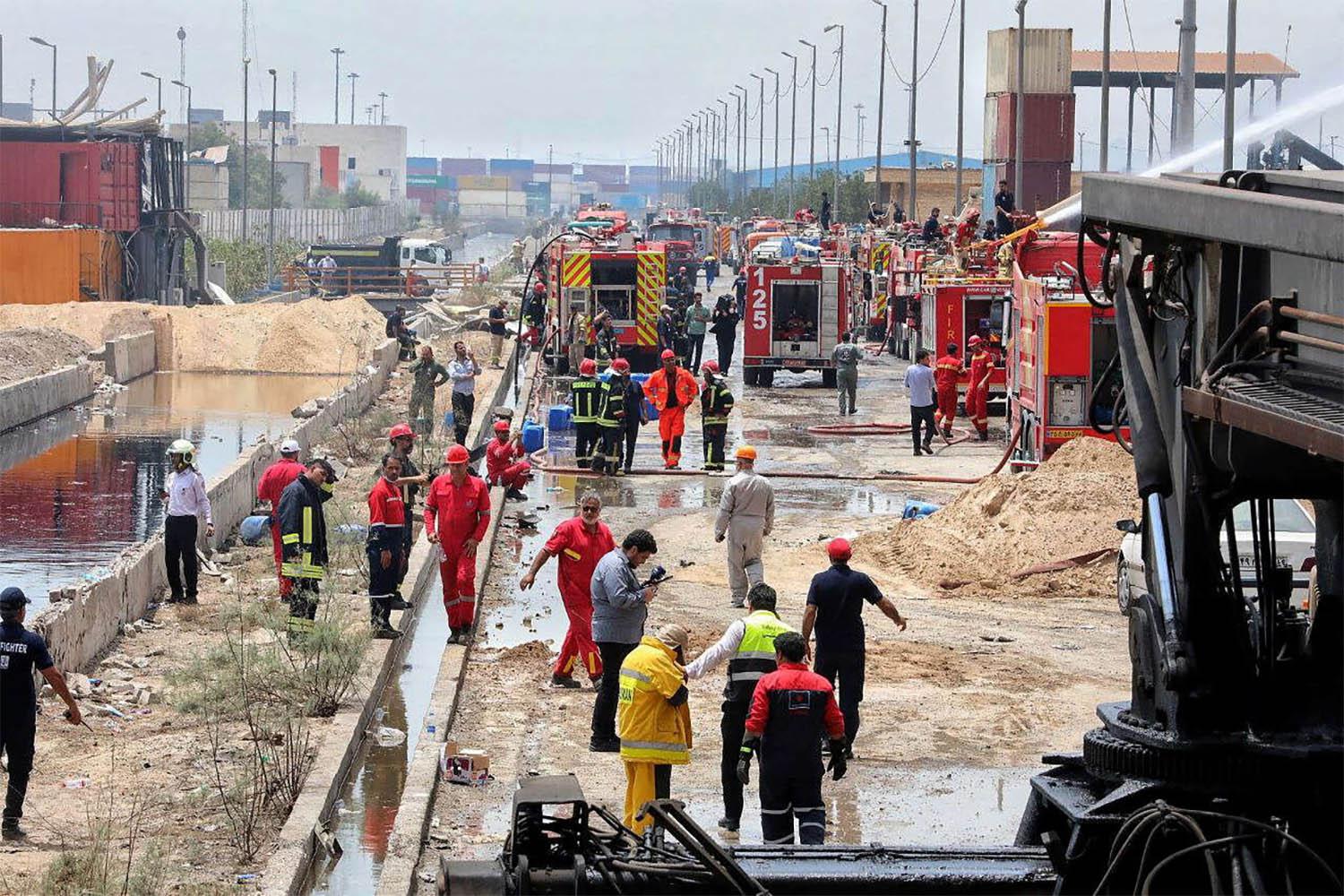 Iranian Red Crescent rescuers work following an explosion at the Shahid Rajaee port in Bandar Abbas