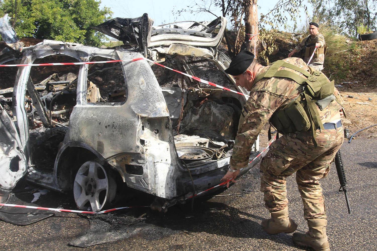 Lebanese security forces inspect the scene of the Israeli airstrike in Baawerta