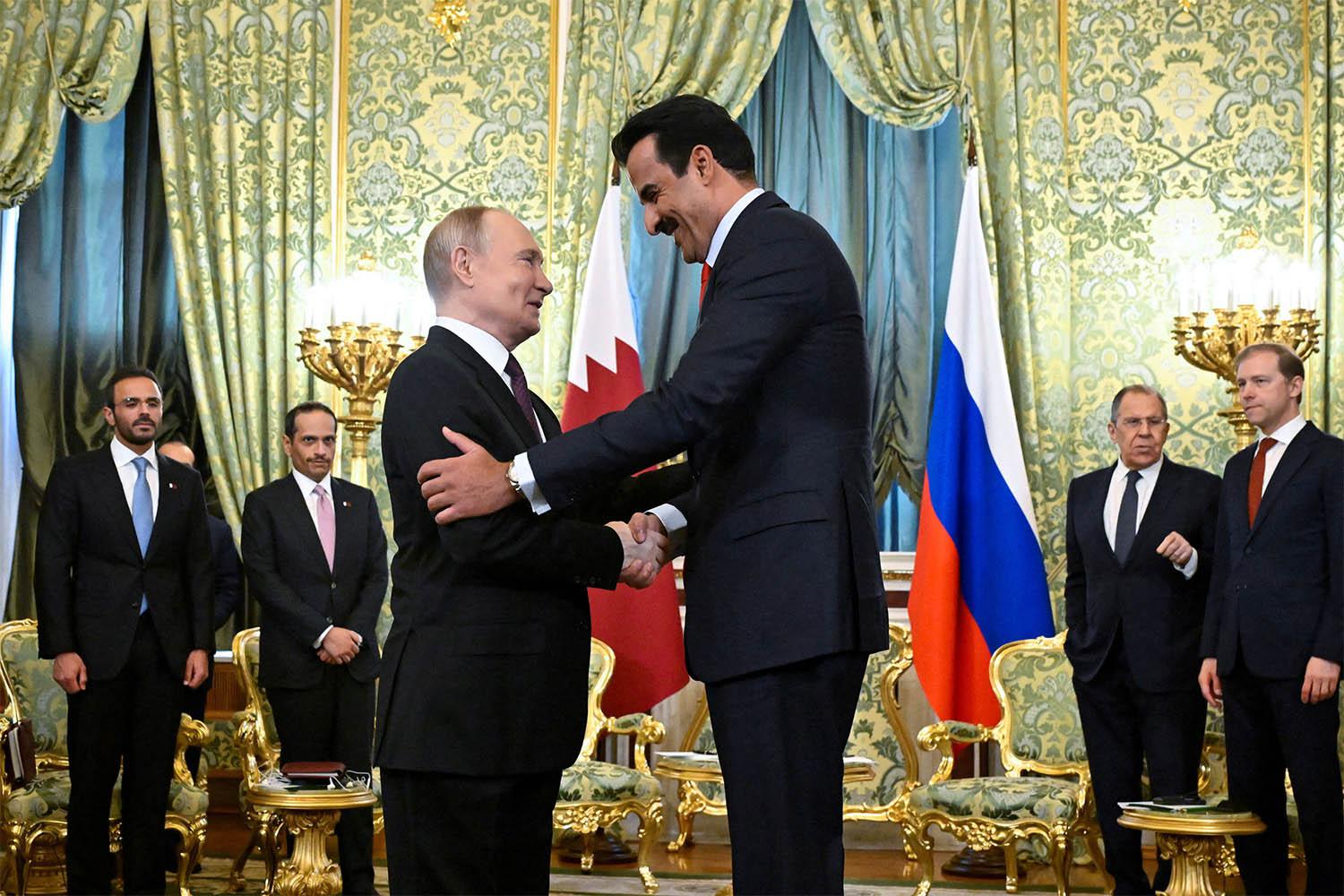 Russia's President Vladimir Putin shakes hands with Qatar's Emir Sheikh Tamim bin Hamad Al Thani at the Kremlin