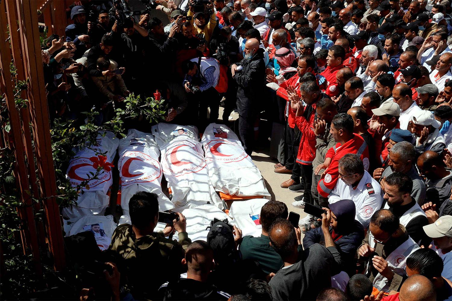 Palestinians mourn medics, who came under Israeli fire while on a rescue mission, after their bodies were recovered