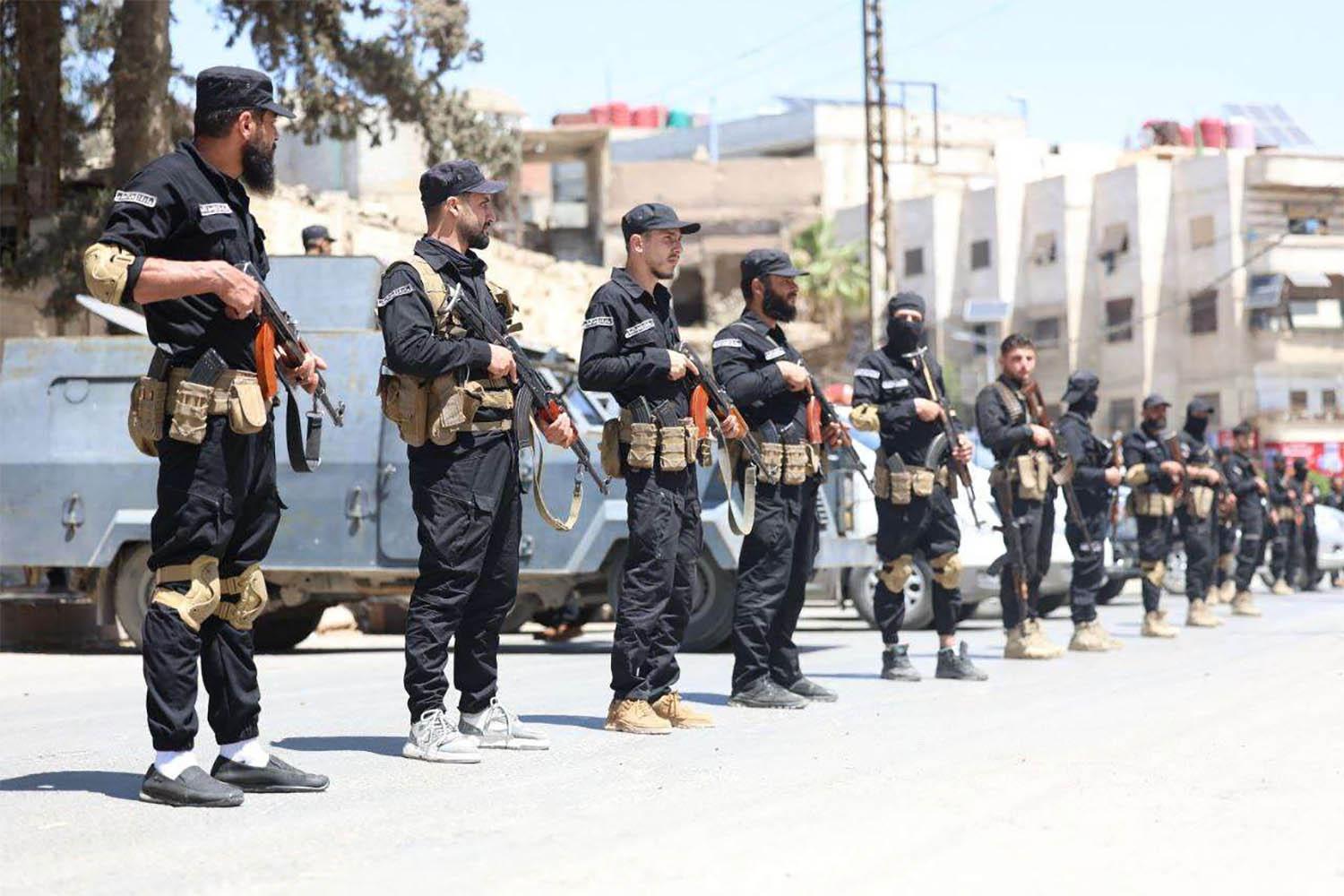 yria's security forces standing guard in a street in the mostly Druze and Christian Jaramana suburb of Damascus