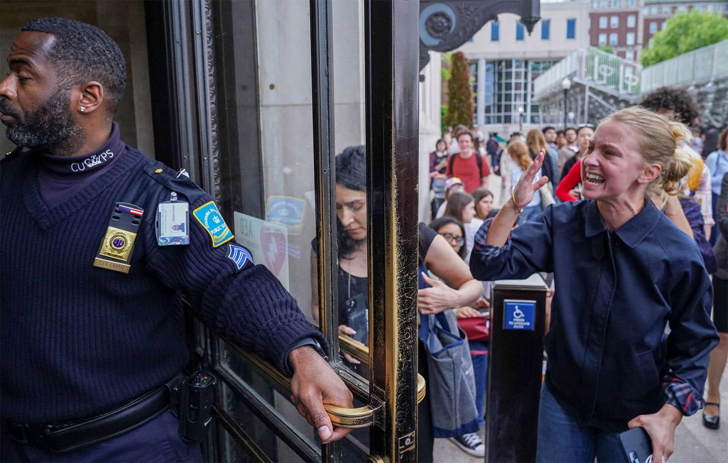 A pro-Palestinian protester yells to let students out of the Butler Library on the campus of Columbia University in New York