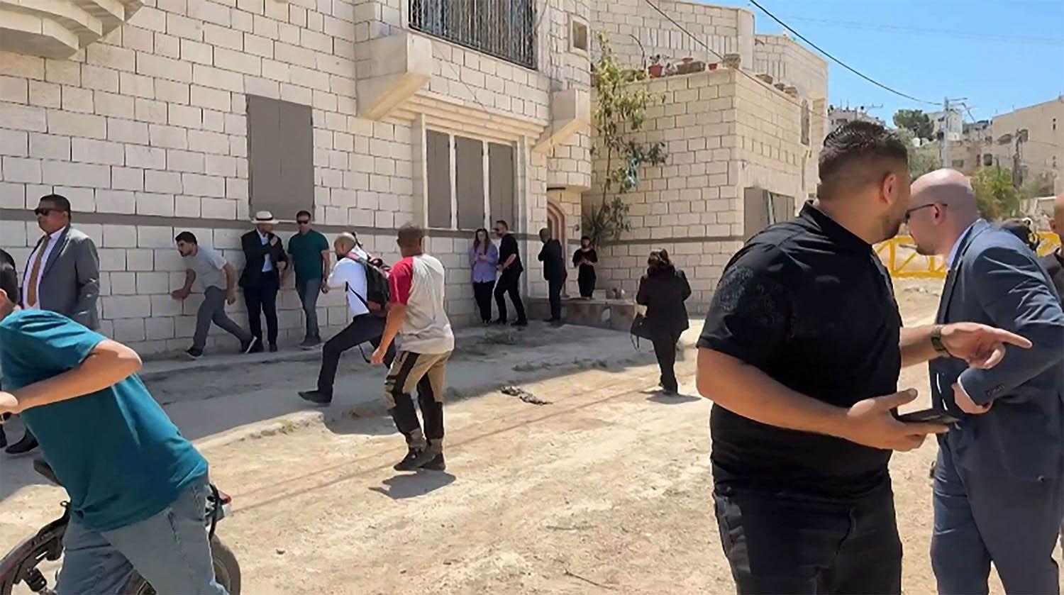 Members of a diplomatic delegation from the European Union reacting after shots were fired as they gathered in Jenin camp