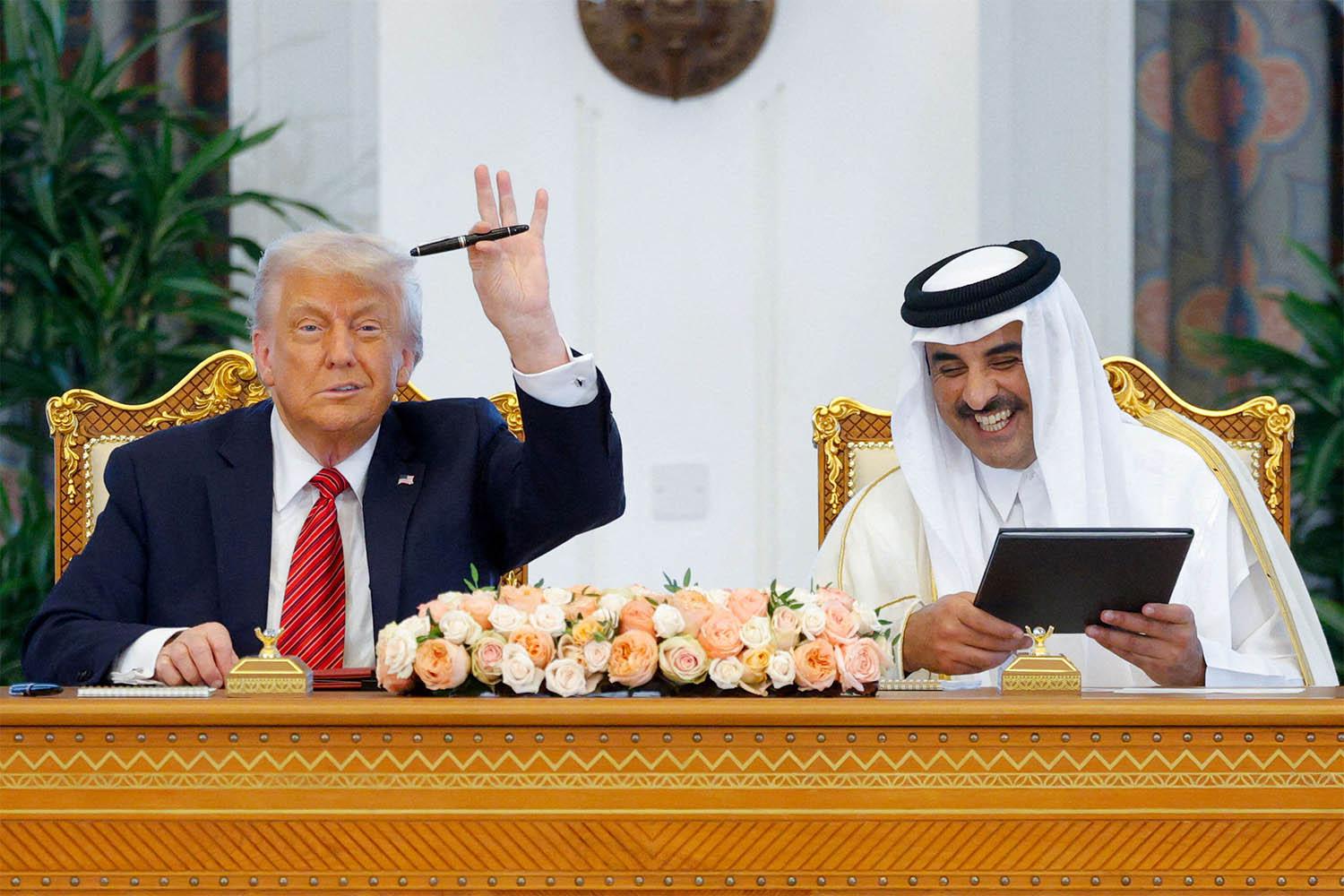 US President Donald Trump and Qatar's Emir Tamim bin Hamad Al Thani attend a signing ceremony in Doha