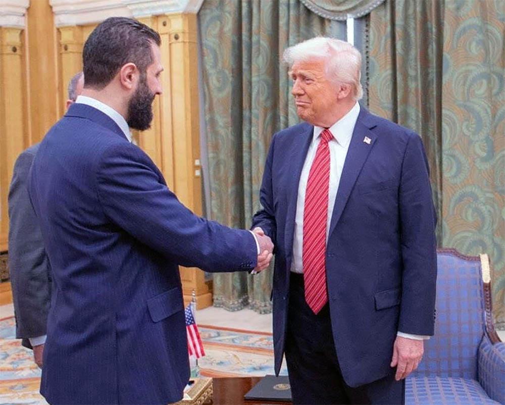 Trump shaking hands with Sharaa