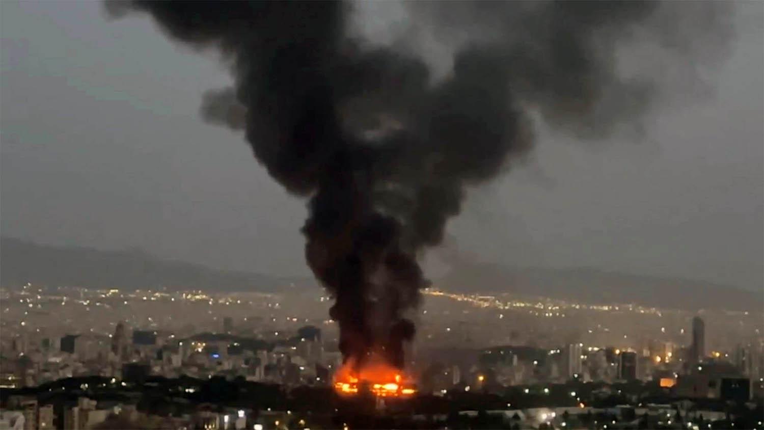 Smoke rises from a fire in Tehran as the Israel-Iran air war continues