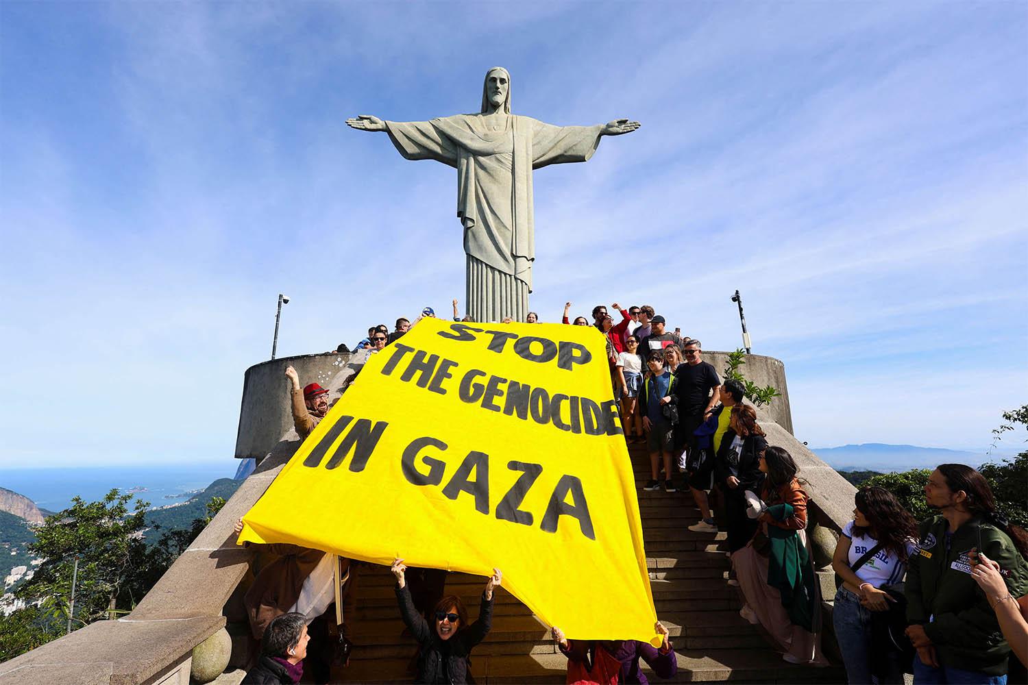 Activists in Rio de Janeiro hold a banner that reads Stop the genocide in Gaza, during a protest to demand an immediate ceasefire in the region and the urgent entry of humanitarian aid for the Palestinians
