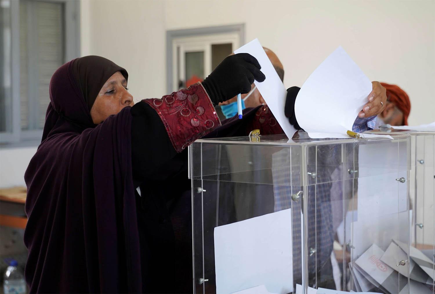 A woman casts her vote at a polling station during parliamentary and local elections, in Casablanca, Morocco September 8, 2021