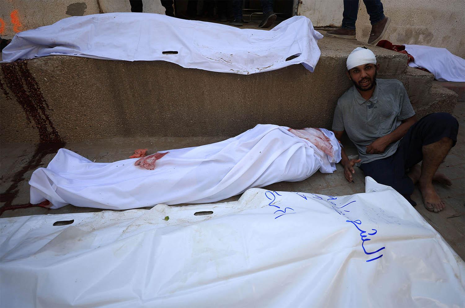 A mourner reacts during the funeral of Palestinians killed in overnight Israeli strikes at Al-Shifa Hospital in Gaza City