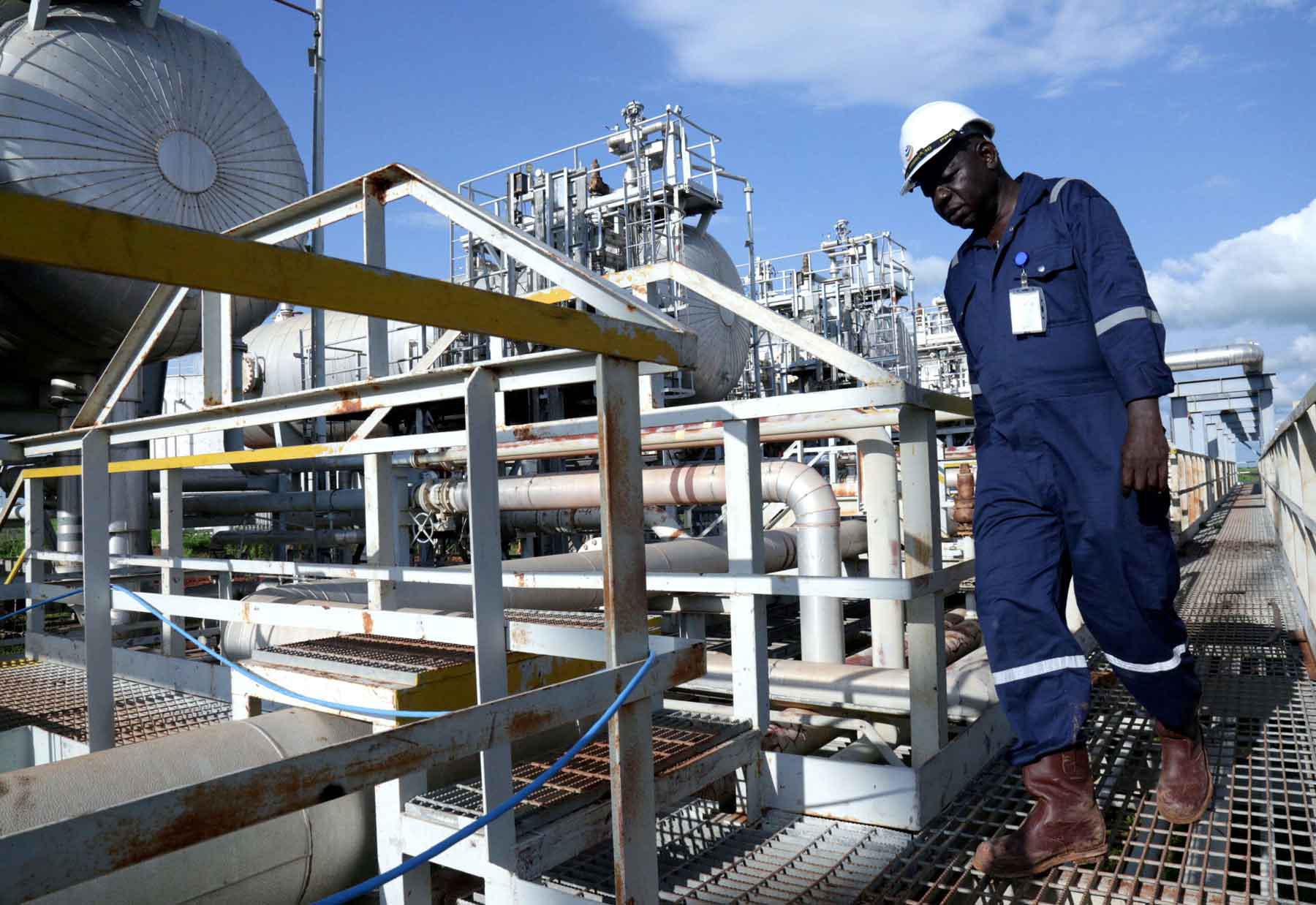 A worker walks by an oil well at the Toma South oil field to Heglig, in Ruweng State, South Sudan.