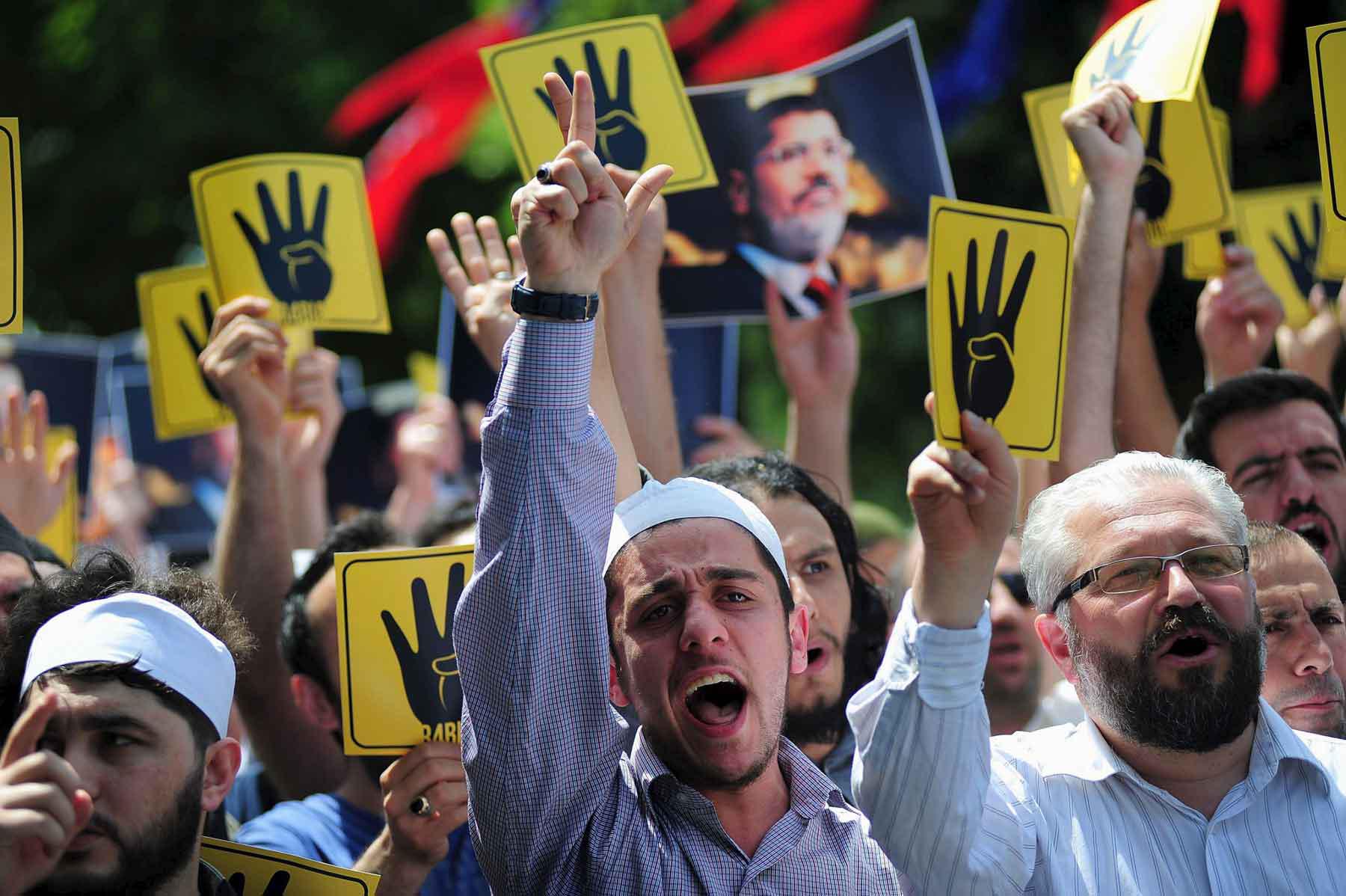 A 2015 file picture shows pro-Islamist demonstrators holding signs that show the Rabaa hand gesture, which symbolises support for the Muslim Brotherhood, during a rally in in Istanbul, Turkey. 