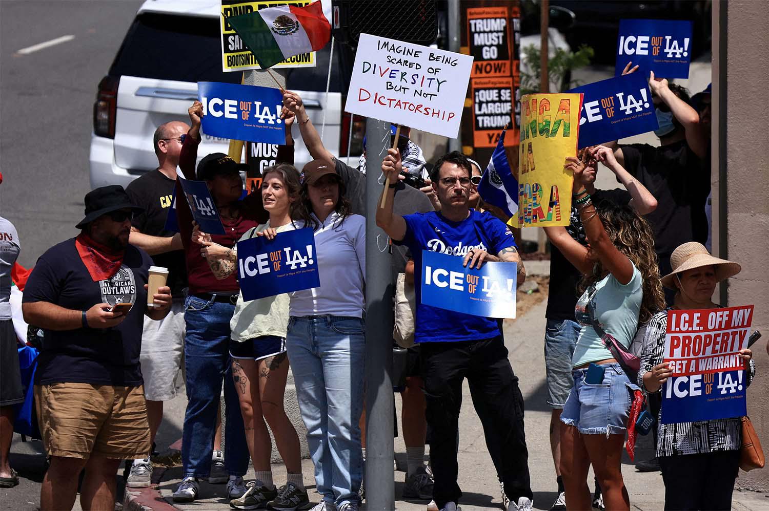 Dodgers fans protest against the US Immigration and Customs Enforcement (ICE) and federal immigration sweeps  in Los Angeles