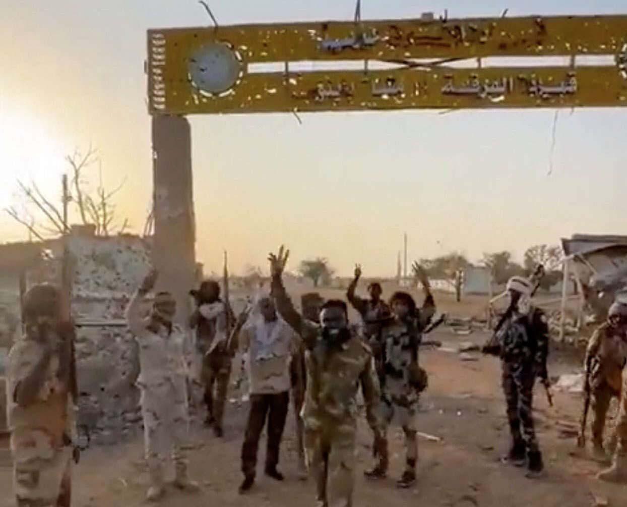 Members of Sudans paramilitary Rapid Support Forces (RSF) stand in front of the main gate of the 22nd SAF Infantry Division, in Babanusa