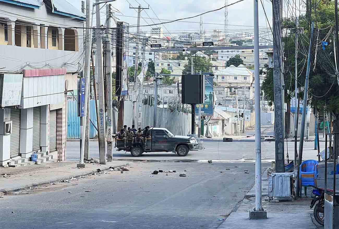 A truck carrying Somali security forces drives across a street ahead of a protest against Somalia's President