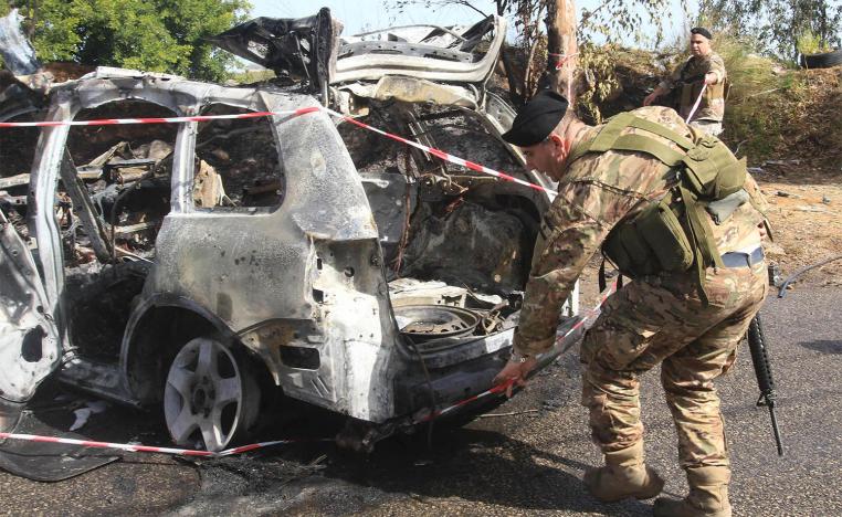 Lebanese security forces inspect the scene of the Israeli airstrike in Baawerta